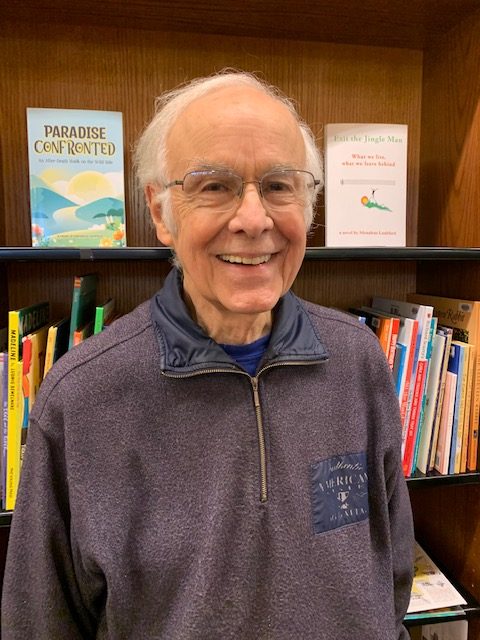 Menalcus Lankford standing in front of a bookshelf